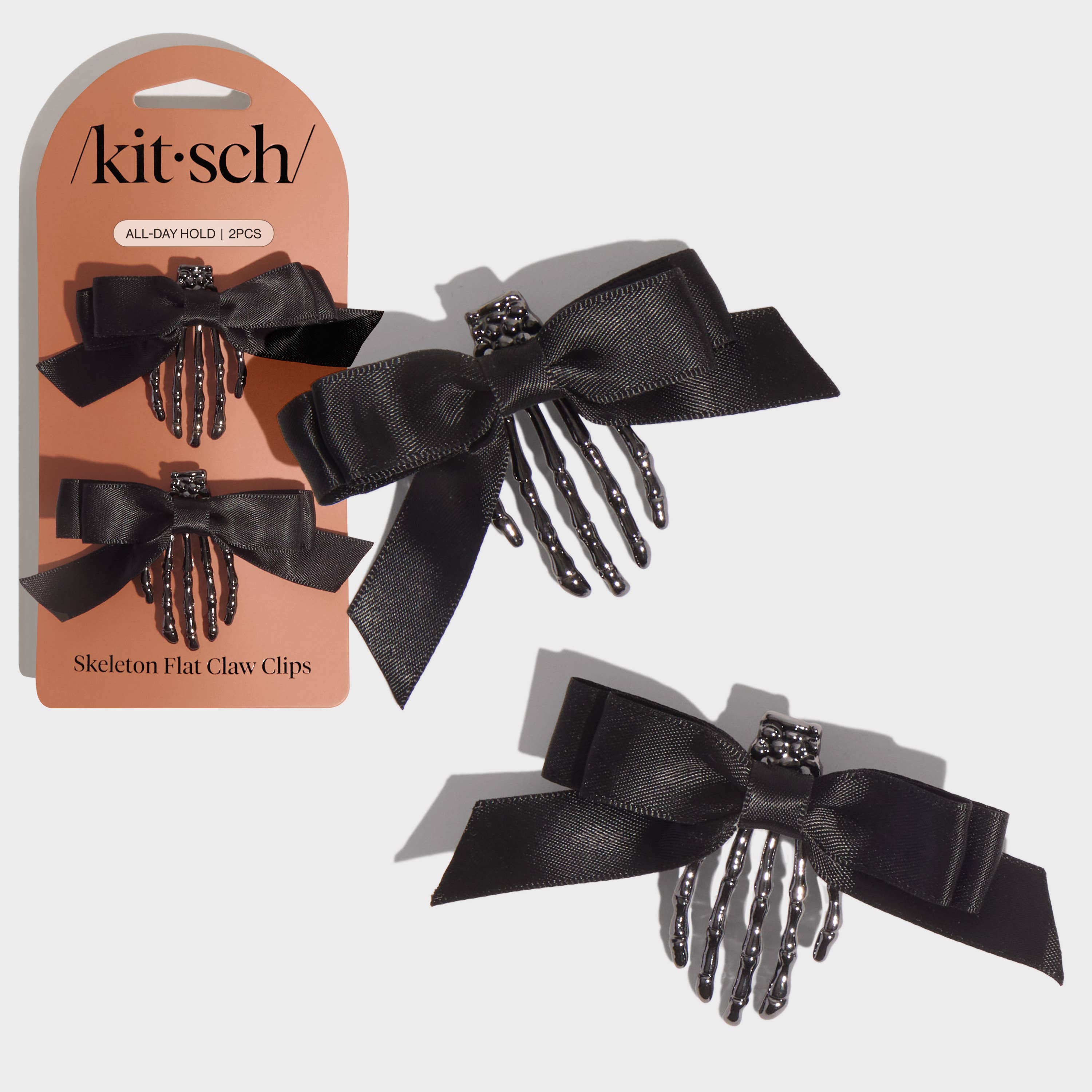 Black skeleton hand hair clips with packaging on a white background