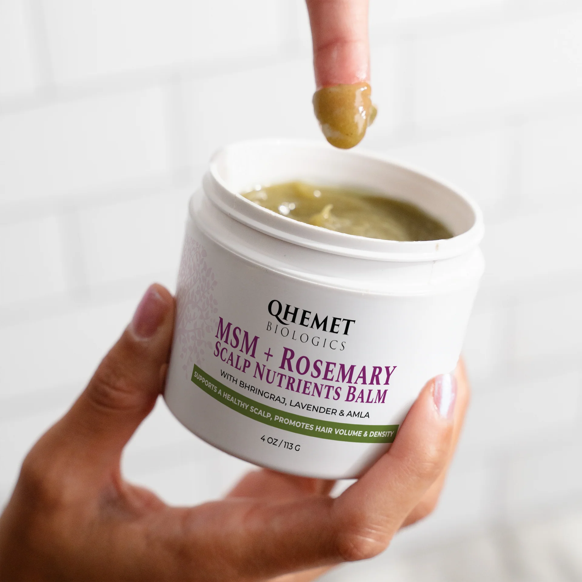 QHemet Biologics MSM + Rosemary Scalp Nutrients Balm being applied with a finger