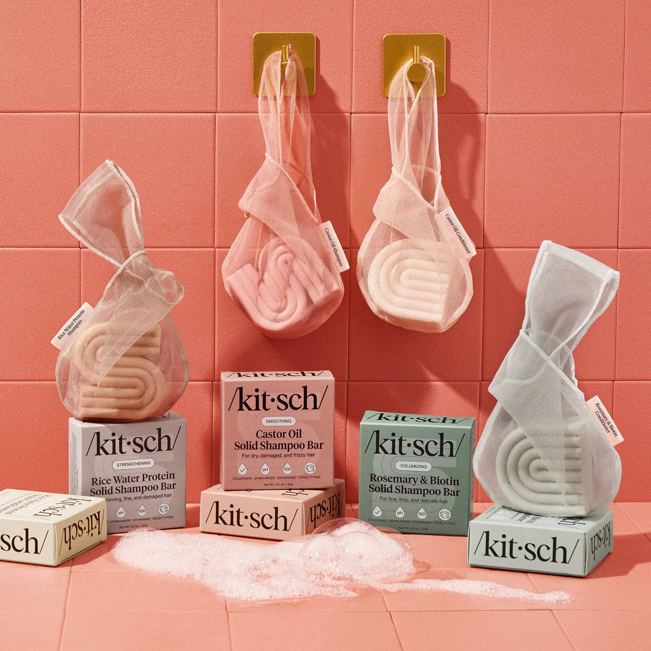 Kitsch solid shampoo bars and boxes on a pink tiled background
