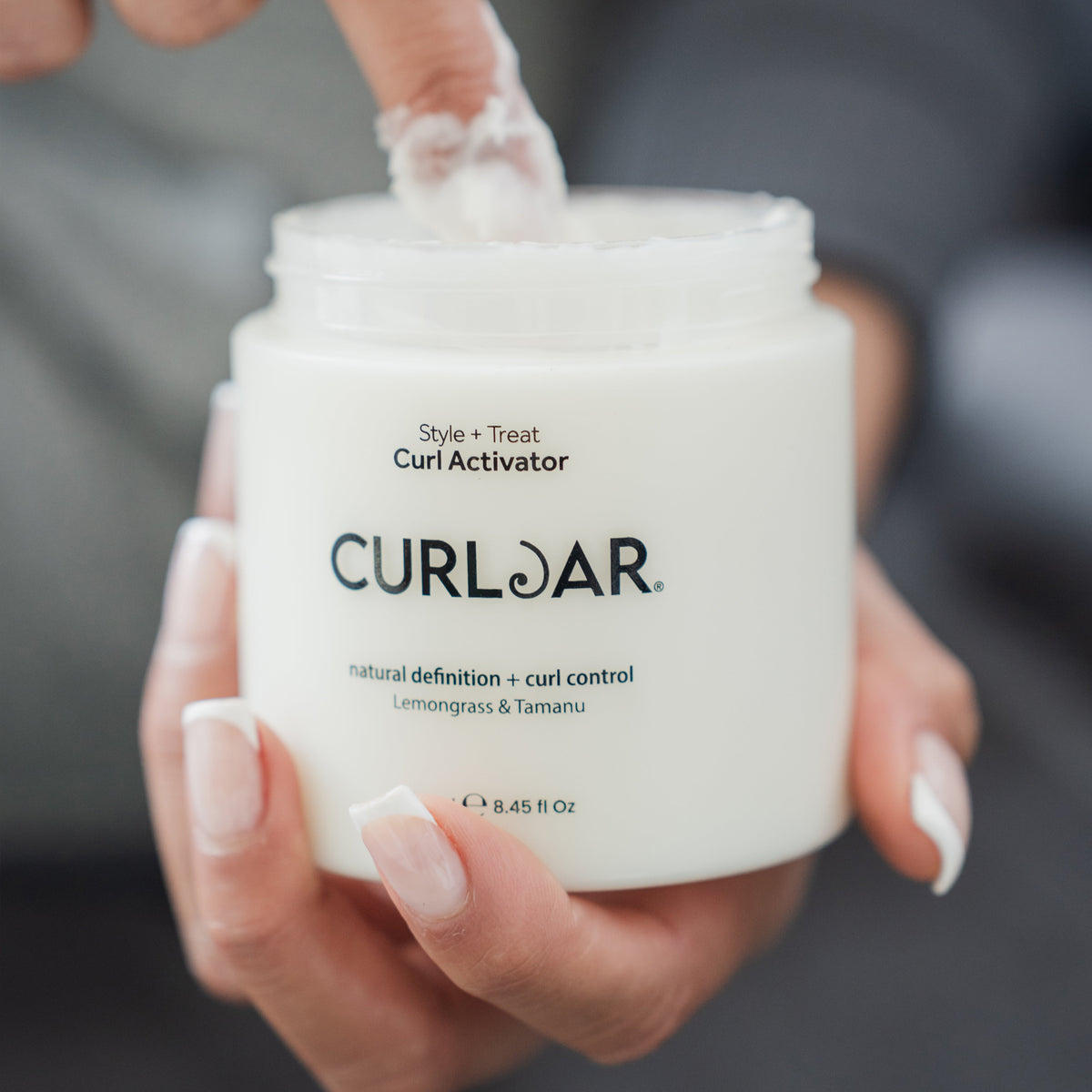 Finger inside Curl Jar Curl Activator Gel