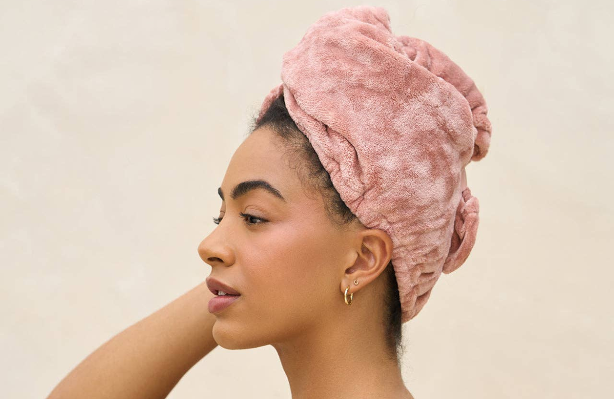 kitsch microfiber hair towel pink blush wrapped around a womans head. 