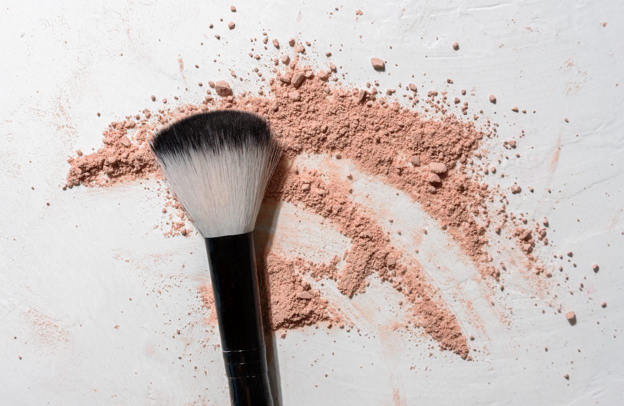 makeup brush on a background of powdered blush