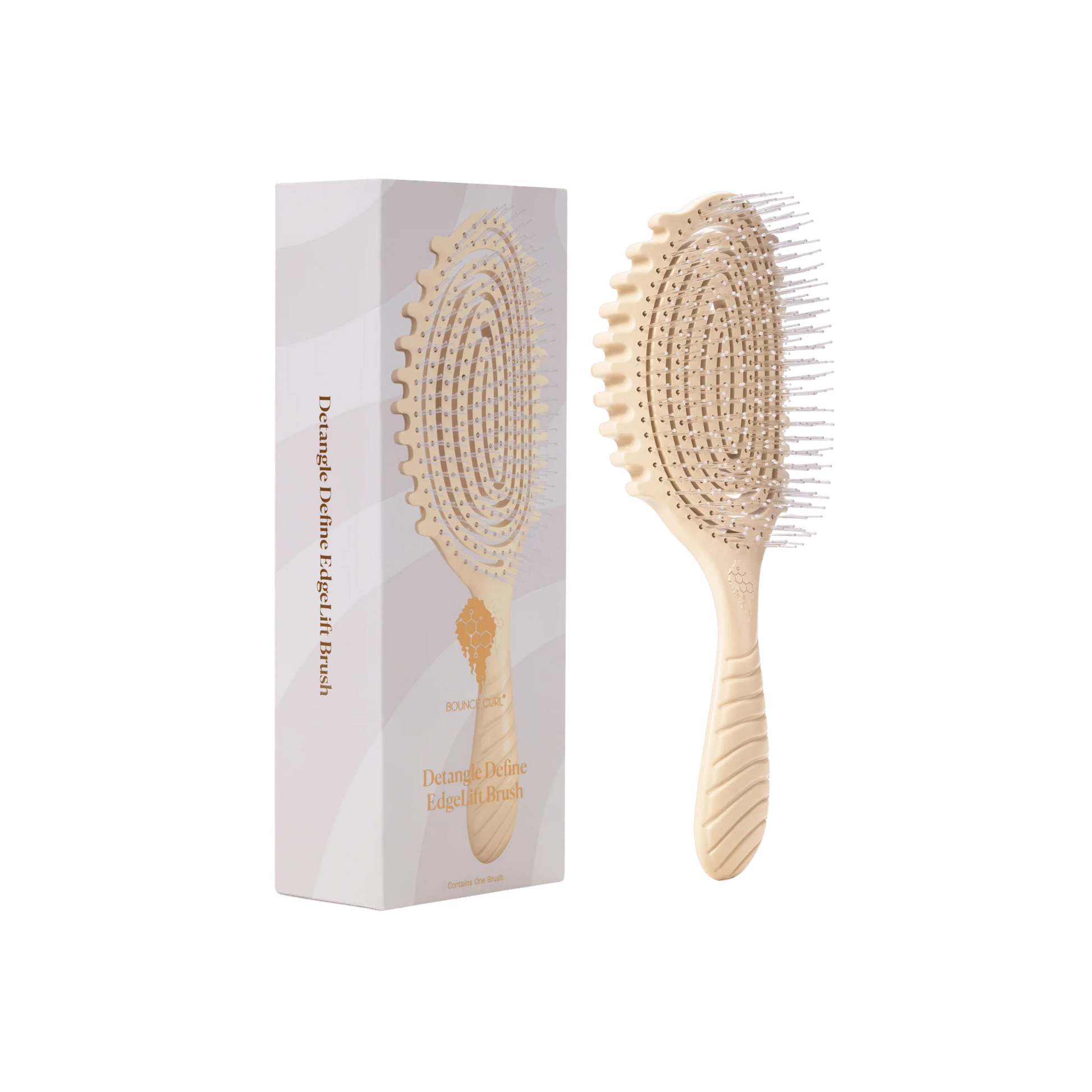 A bounce curl detangle define edgelift brush or paddle hairbrush shown next to its white and pale pink packaging box on a plain white background by Bounce Curl. 