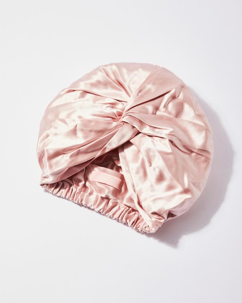 Pink silk bonnet on a light gray background