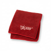 Red towel with 'glaze' logo on a light pink background