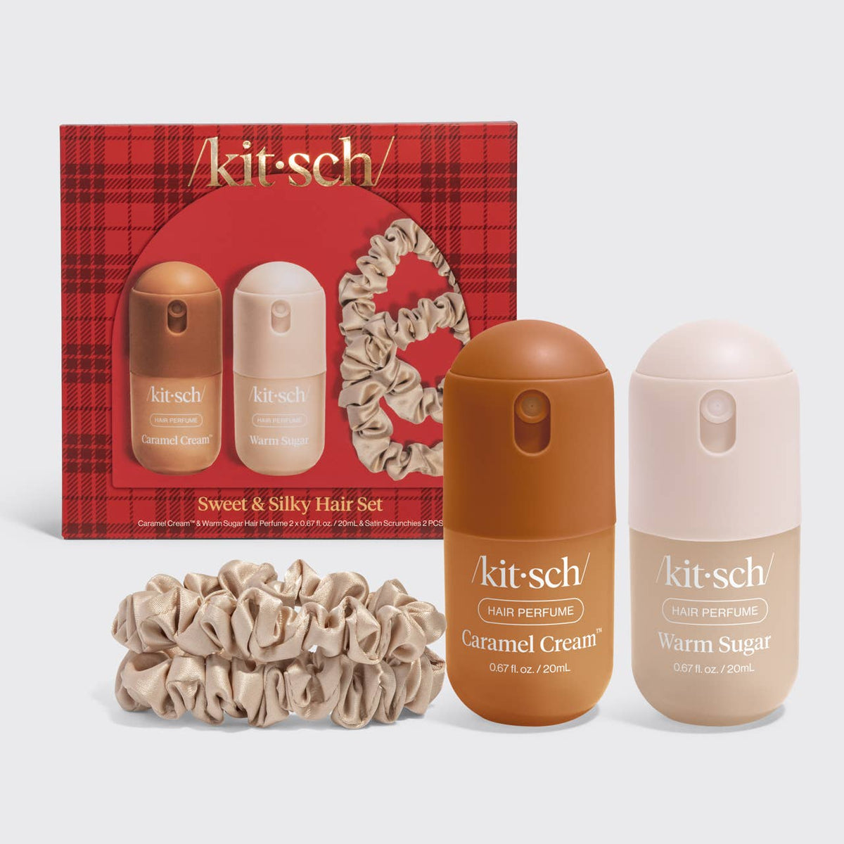 Kitsch Sweet & Silky Hair Set featuring a red plaid gift box, two hair perfume bottles (Caramel Cream and Warm Sugar), and two beige satin scrunchies on a light gray background.