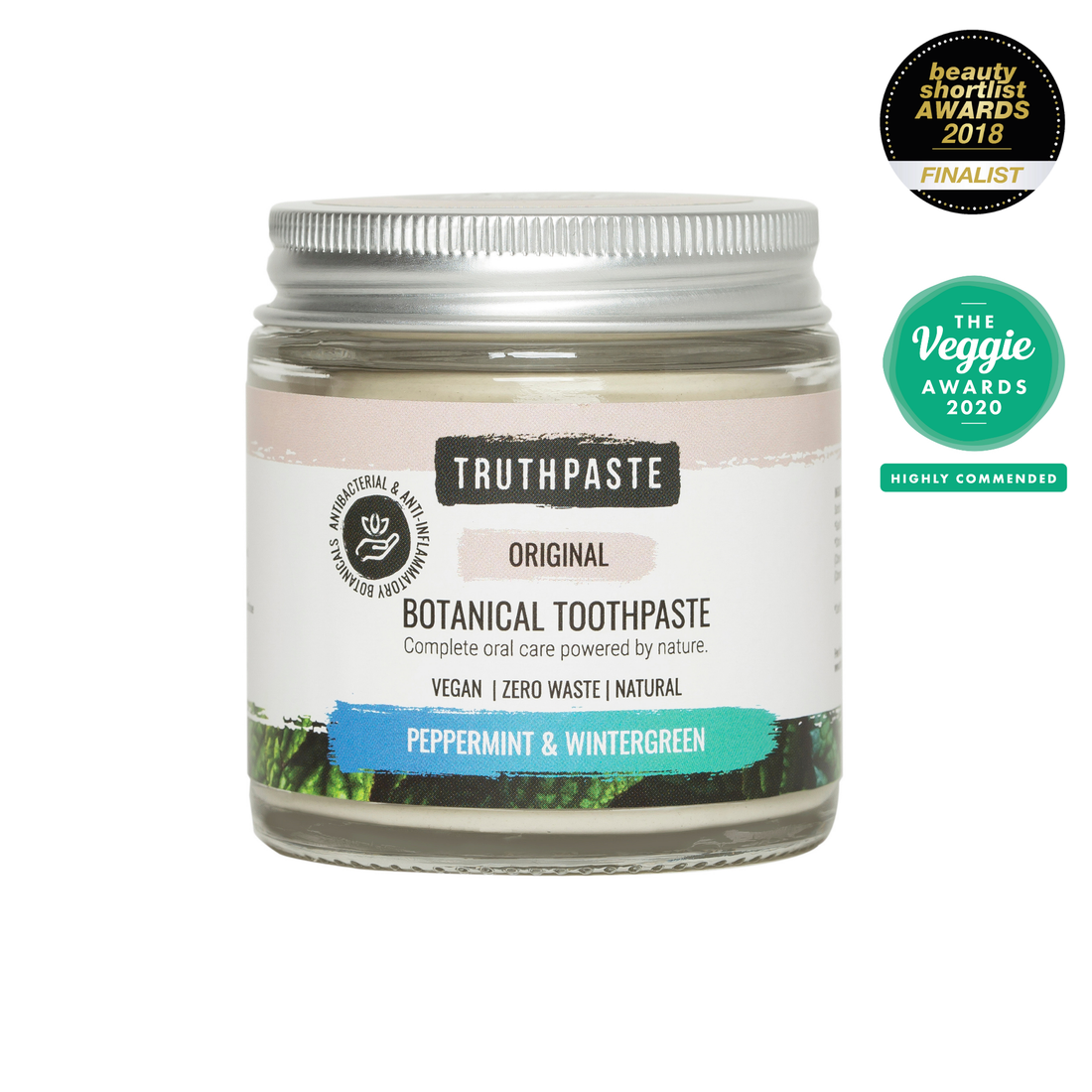 Jar of Truthpaste botanical toothpaste with awards on a white background