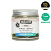 Jar of Truthpaste botanical toothpaste with awards on a white background