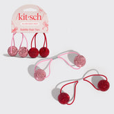 Kitsch bubble hair ties with pink and red glittery bubbles on a white background
