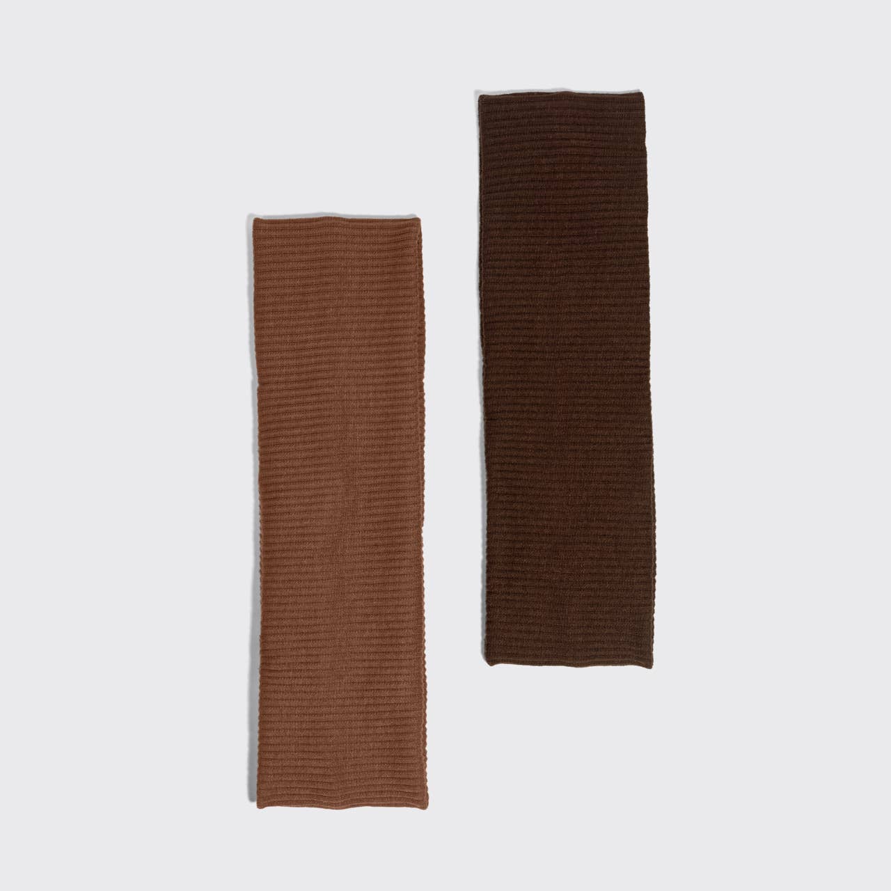 Two ribbed knit rectangular fabric pieces in warm brown and dark brown, displayed vertically on a light gray background.