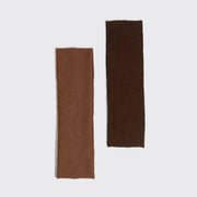 Two ribbed knit rectangular fabric pieces in warm brown and dark brown, displayed vertically on a light gray background.