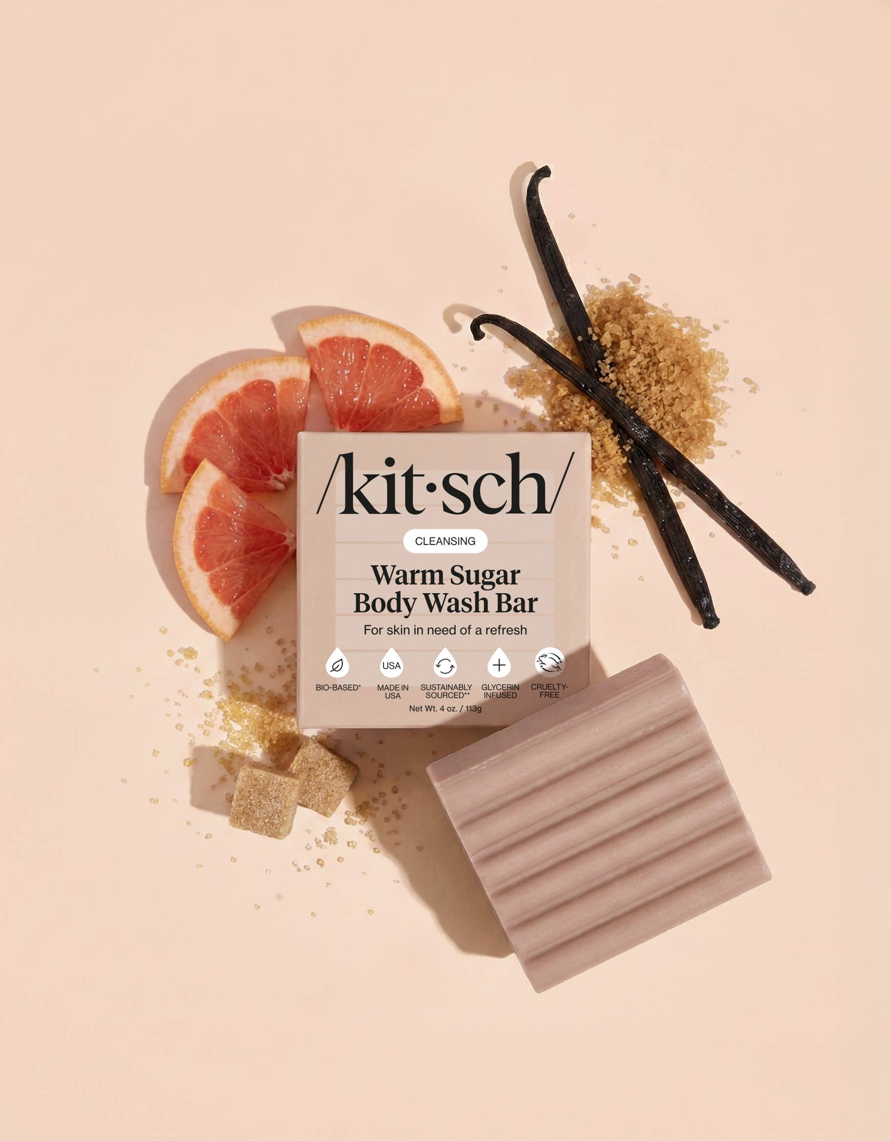 Kit'sch Warm Sugar Body Wash Bar with grapefruit, vanilla bean, and brown sugar on a beige background