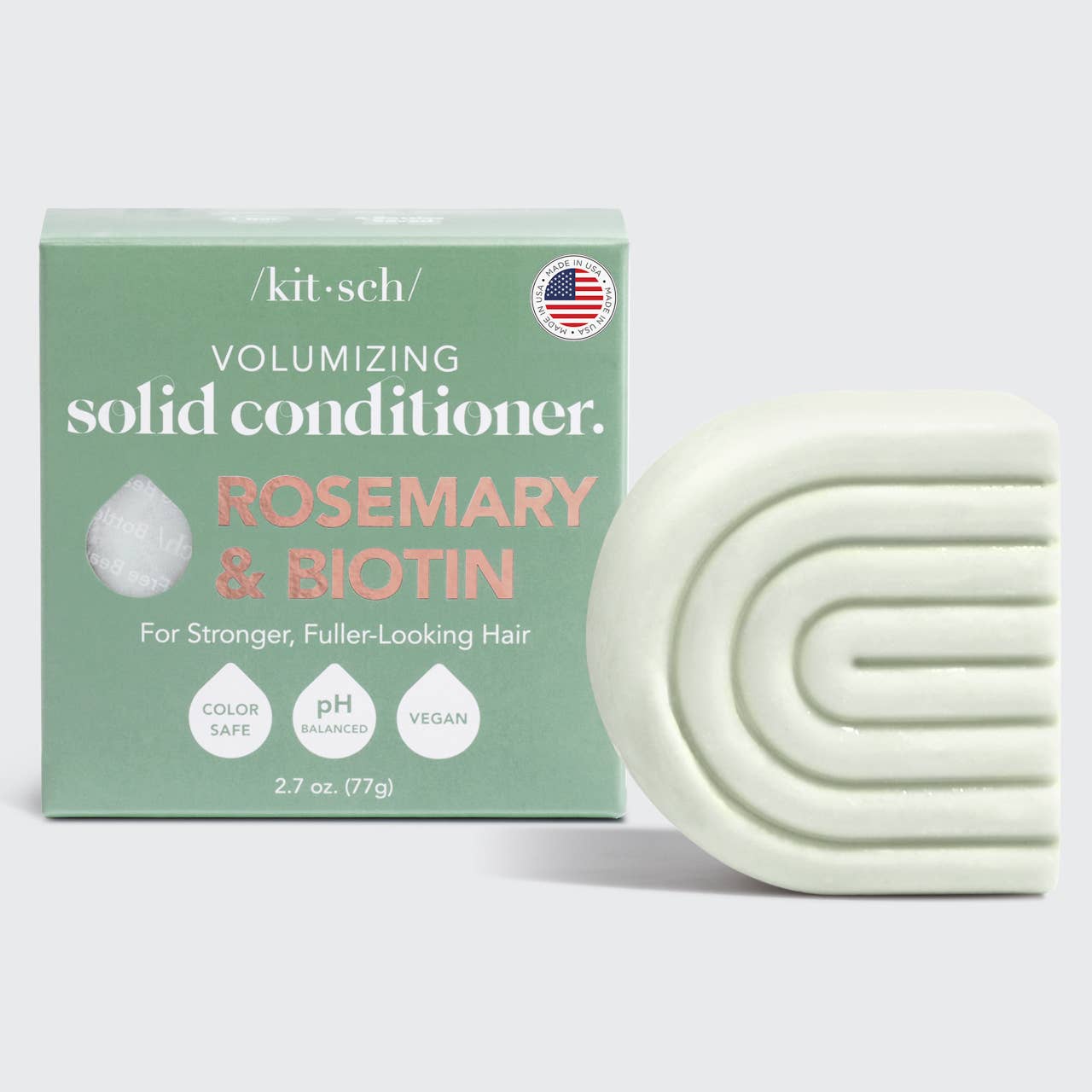 A Kitsch Rosemary & Biotin Volumizing Solid Conditioner Bar next to its packaging, which is labeled as vegan, cruelty-free, and pH balanced.