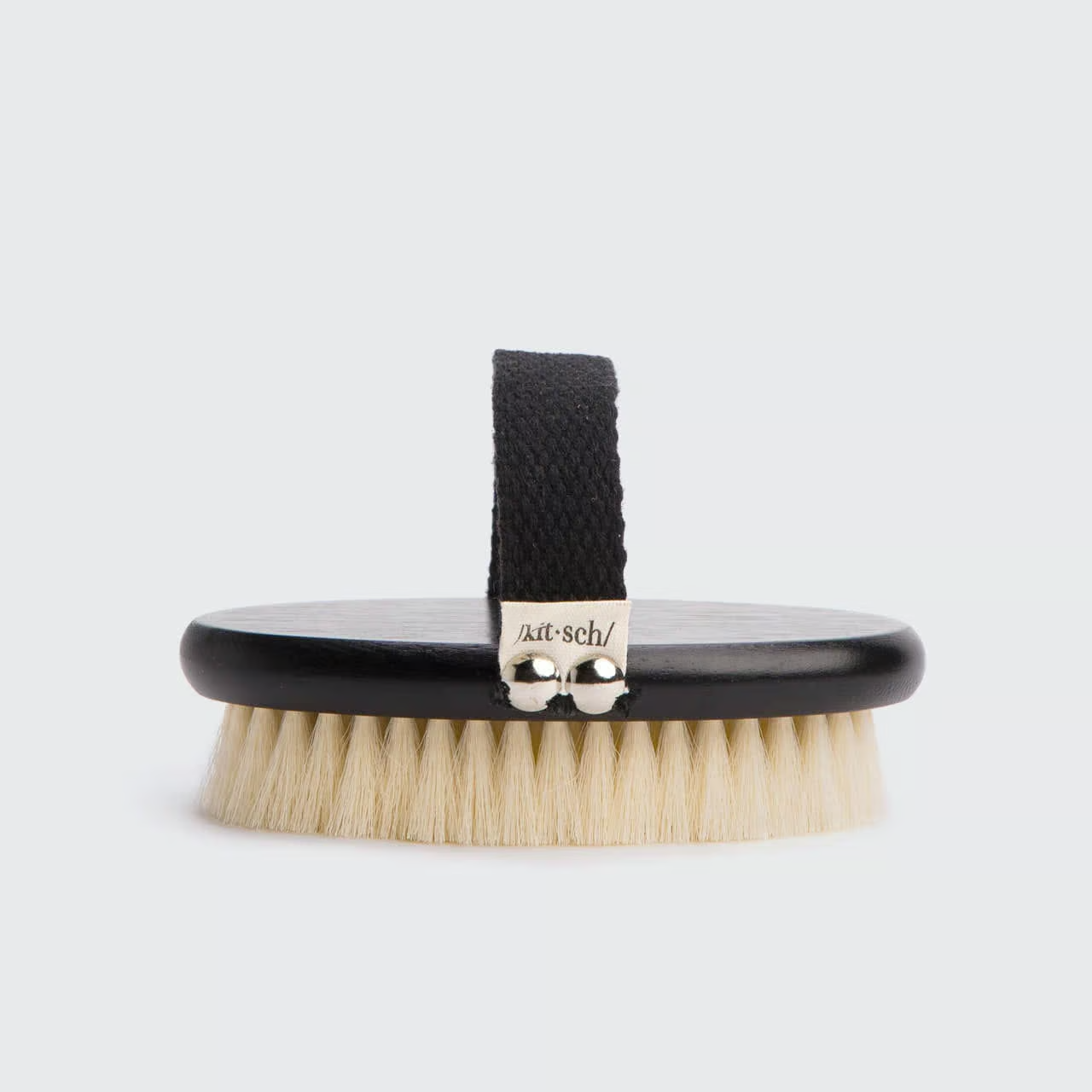 A Kitsch body dry brush with vegan bristles and a black handle, displayed on a white background.