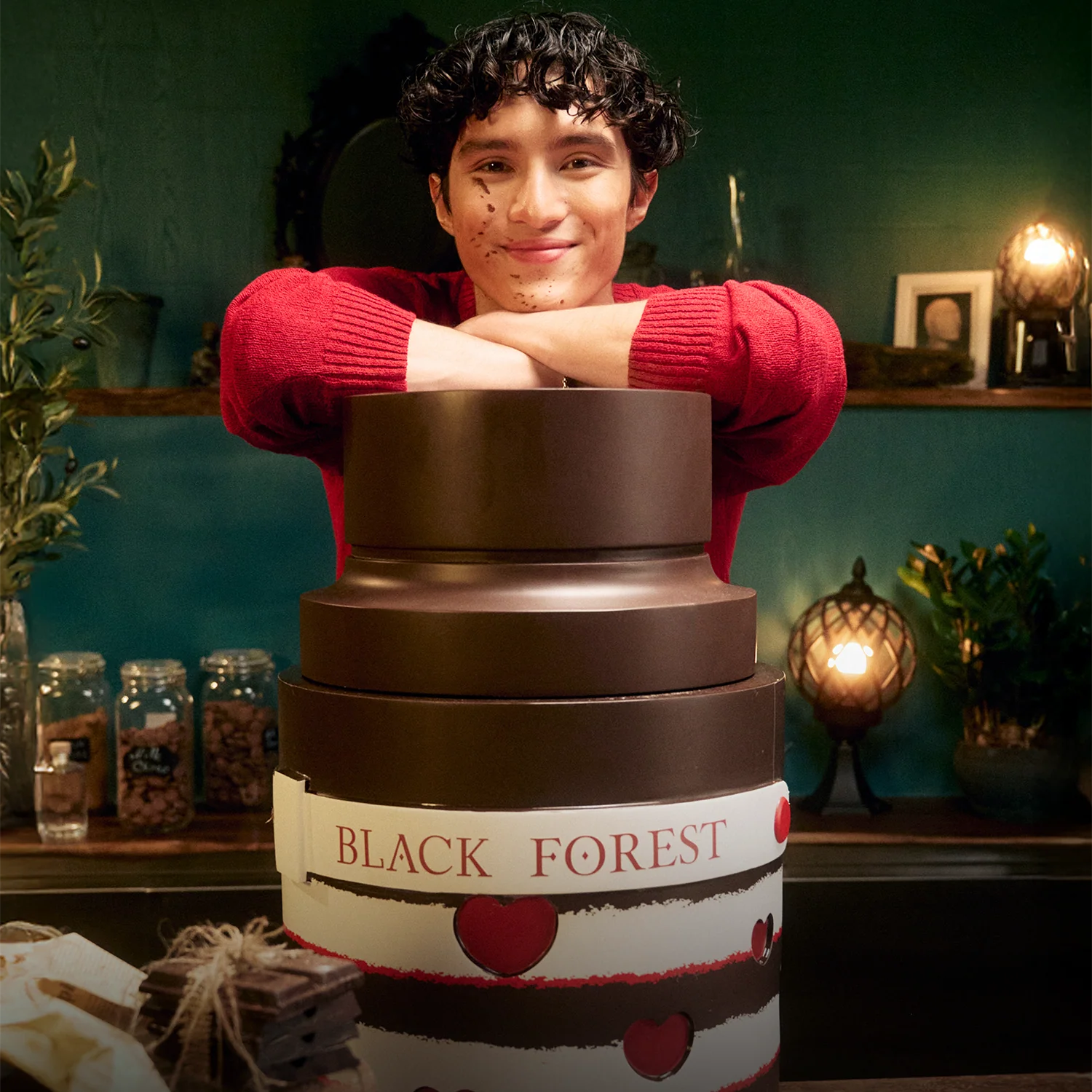 Armaf Odyssey Black Forest Eau De Parfum 100ml displayed in a cozy confectionery-inspired setting, emphasizing its rich sweet gourmand character with notes of vanilla, caramel and cherry.