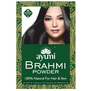 Ayumi Naturals Brahmi Powder packaging featuring a woman with long, glossy black hair. The product is described as 100% natural for hair and skin and is free from PPD, chemicals, peroxide and preservatives, with Ayurvedic-inspired green and gold decorative packaging.