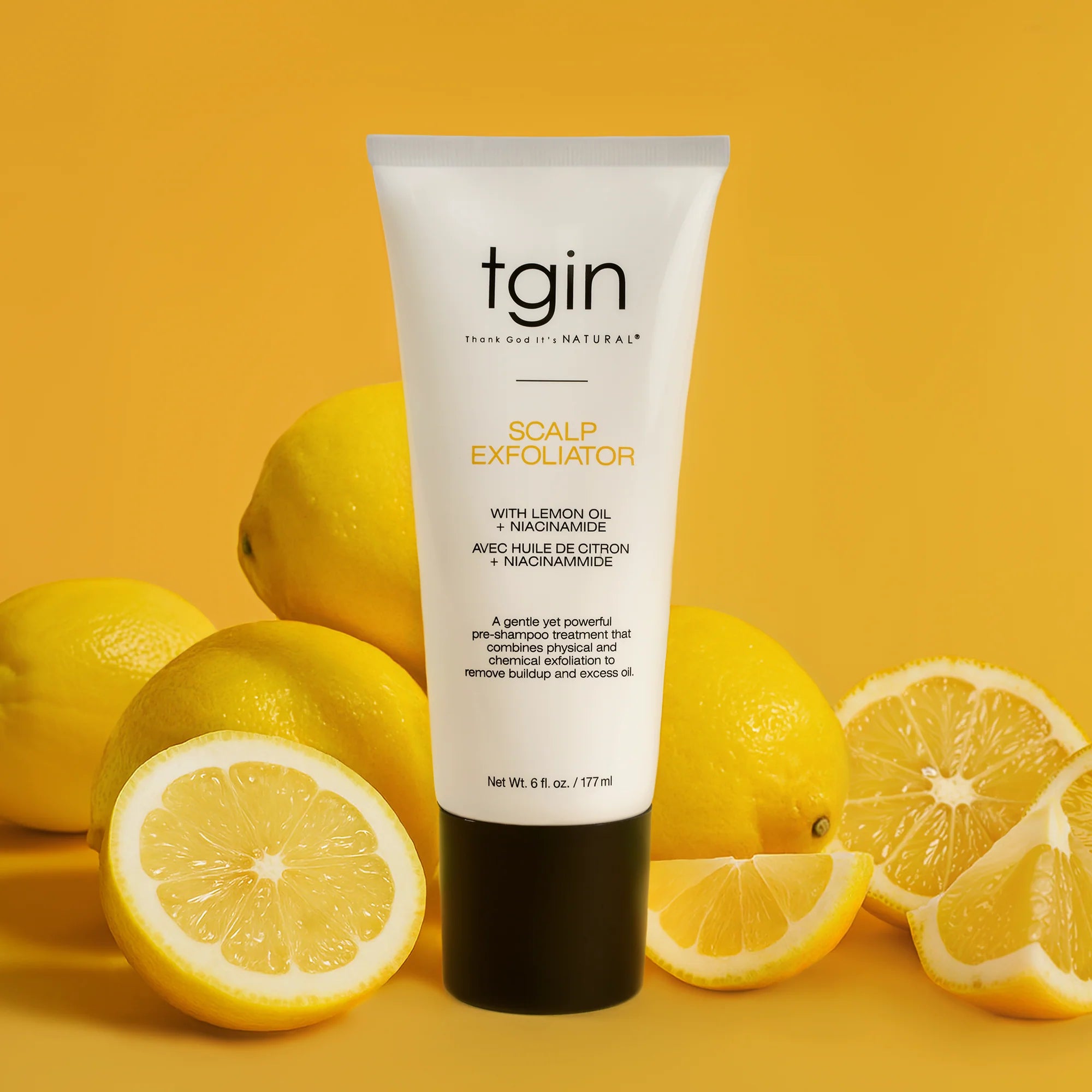 Tube of tgin Scalp Exfoliator with lemons on a yellow background