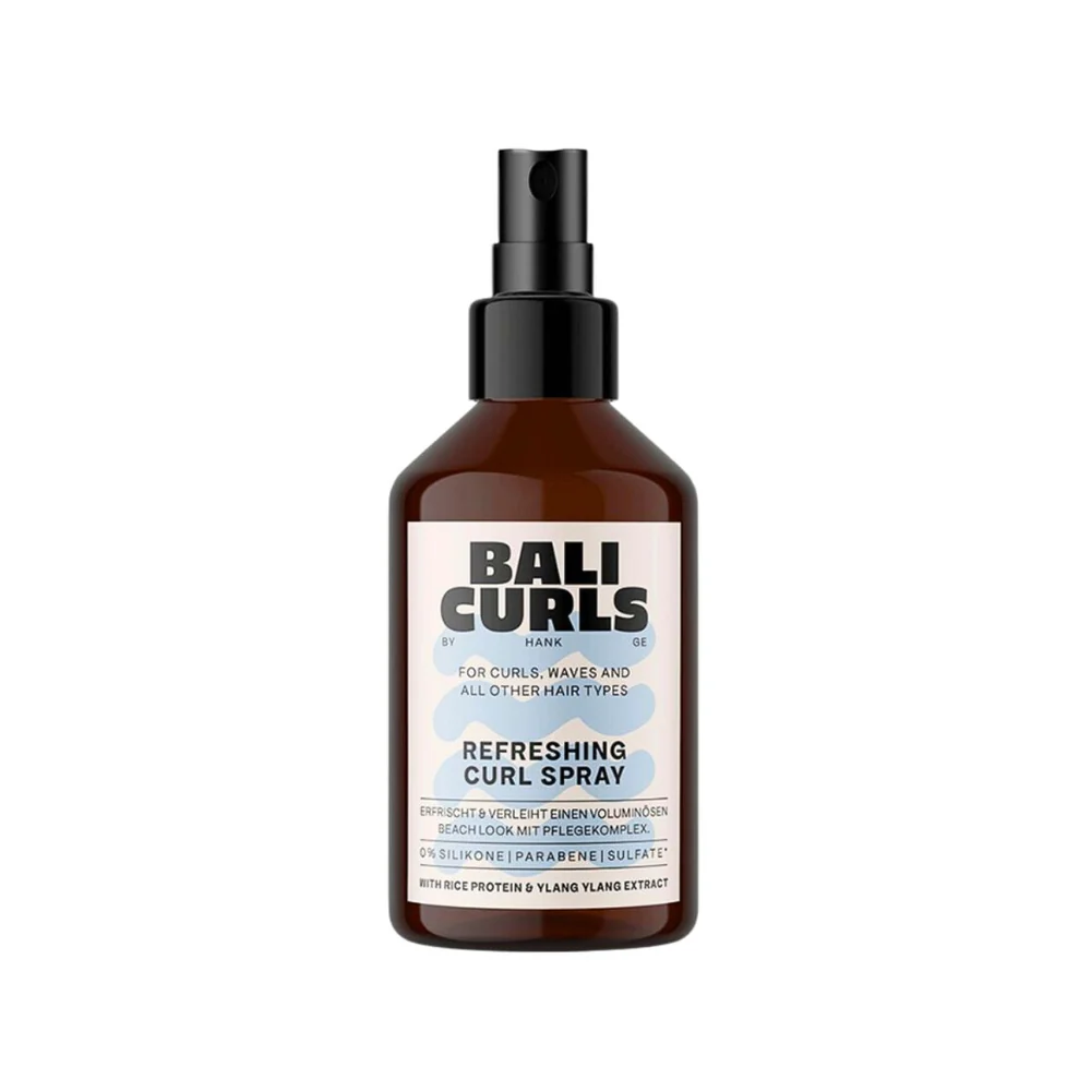 A bottle of Bali Curls Refreshing Curl Spray with a black spray nozzle, labeled for curls, waves, and all hair types.