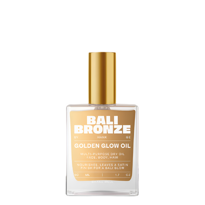 Bottle of Bali Bronze Golden Glow Oil with a gold cap on a white background