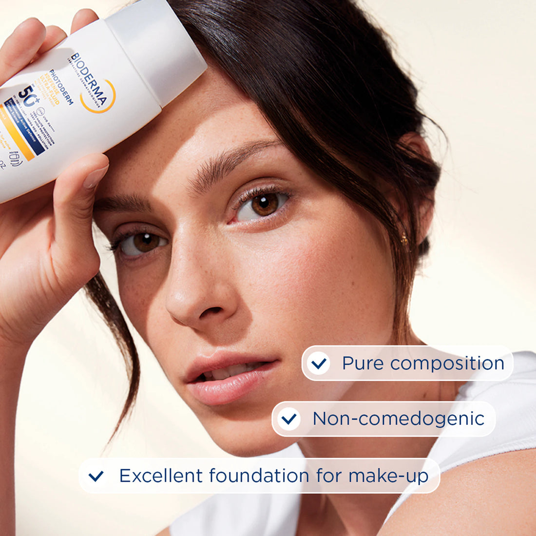 Bioderma Photoderm XDefense Ultra Fluid SPF50+ Invisible 40ml woman holding product with benefits for skin complexion