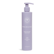 A pump bottle of Innersense Bright Balance Conditioner with a purple label.