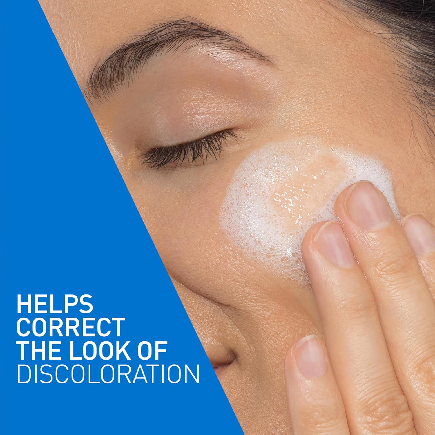 Person applying CeraVe Brightening Vitamin C Cleanser foam to the face to help improve the appearance of discoloration and uneven skin tone.