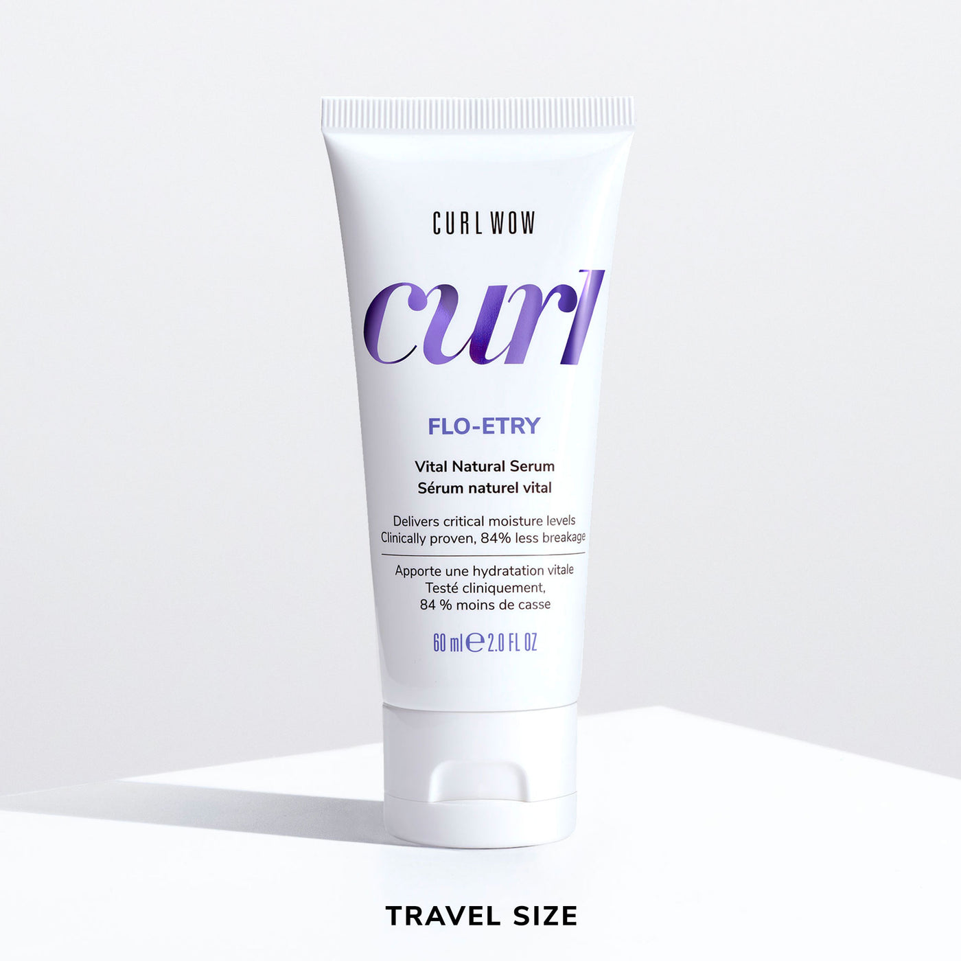 Color Wow Curl Wow Flo-Etry Vital Natural Serum Travel Size 60ml tube on a white background, lightweight hydrating serum that replenishes moisture, strengthens curls, reduces breakage, and improves softness and flexibility.
