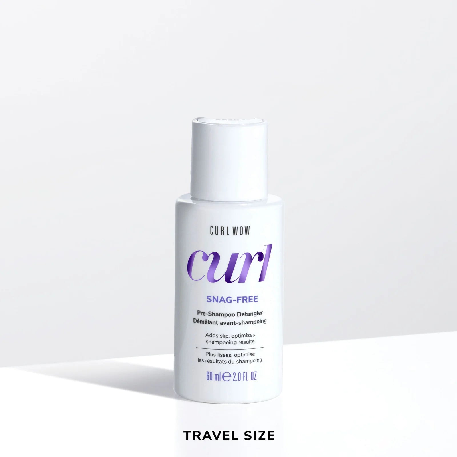 Color Wow Curl Wow Snag-Free Pre-Shampoo Detangler Travel Size 60ml bottle on a white background, pre-shampoo detangling treatment that adds slip, reduces knots, minimises breakage, and prepares curly hair for gentle cleansing.
