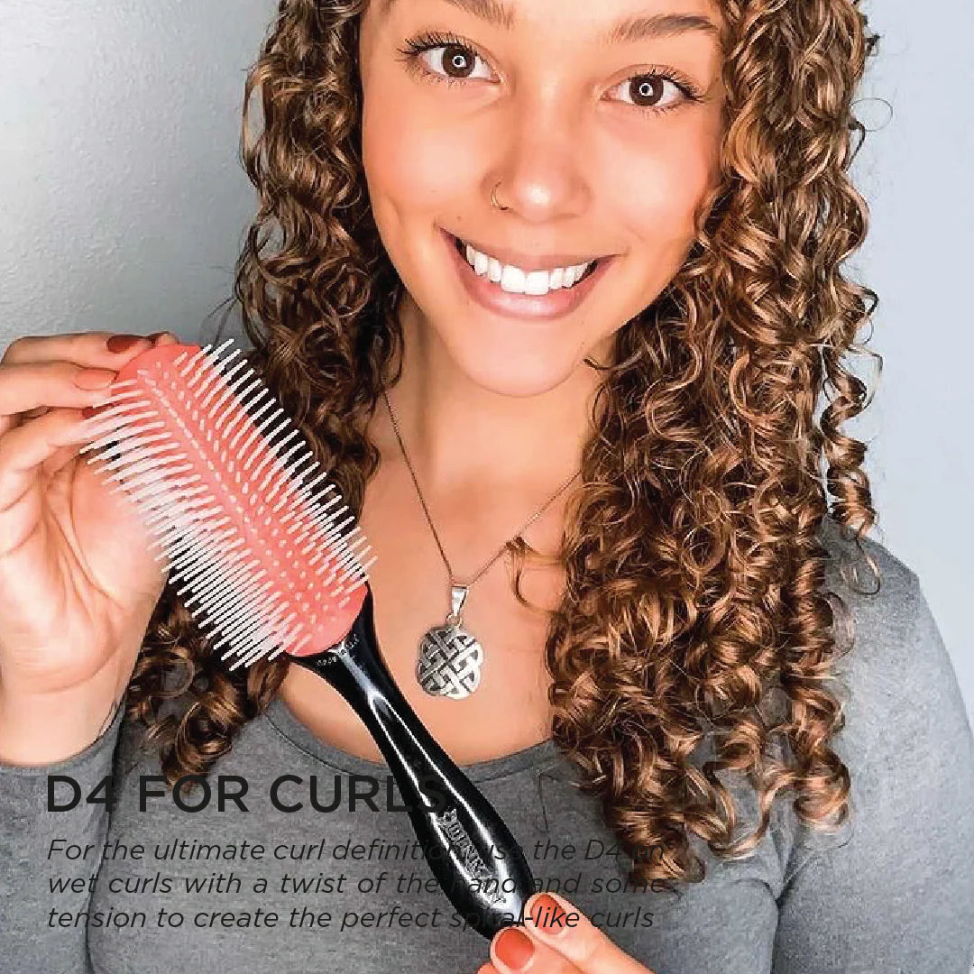 Model using the Denman D4 Original Styler 9-Row Brush to define natural curls and create smooth, defined spiral curls.