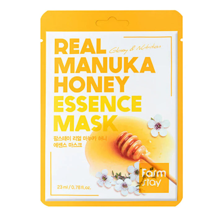 Real Manuka Honey Essence Mask packaging with honey dipper and flowers on a white background