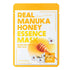 Real Manuka Honey Essence Mask packaging with honey dipper and flowers on a white background