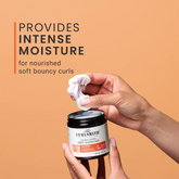 Person holding a jar of Curlesmith product with text about intense moisture on an orange background