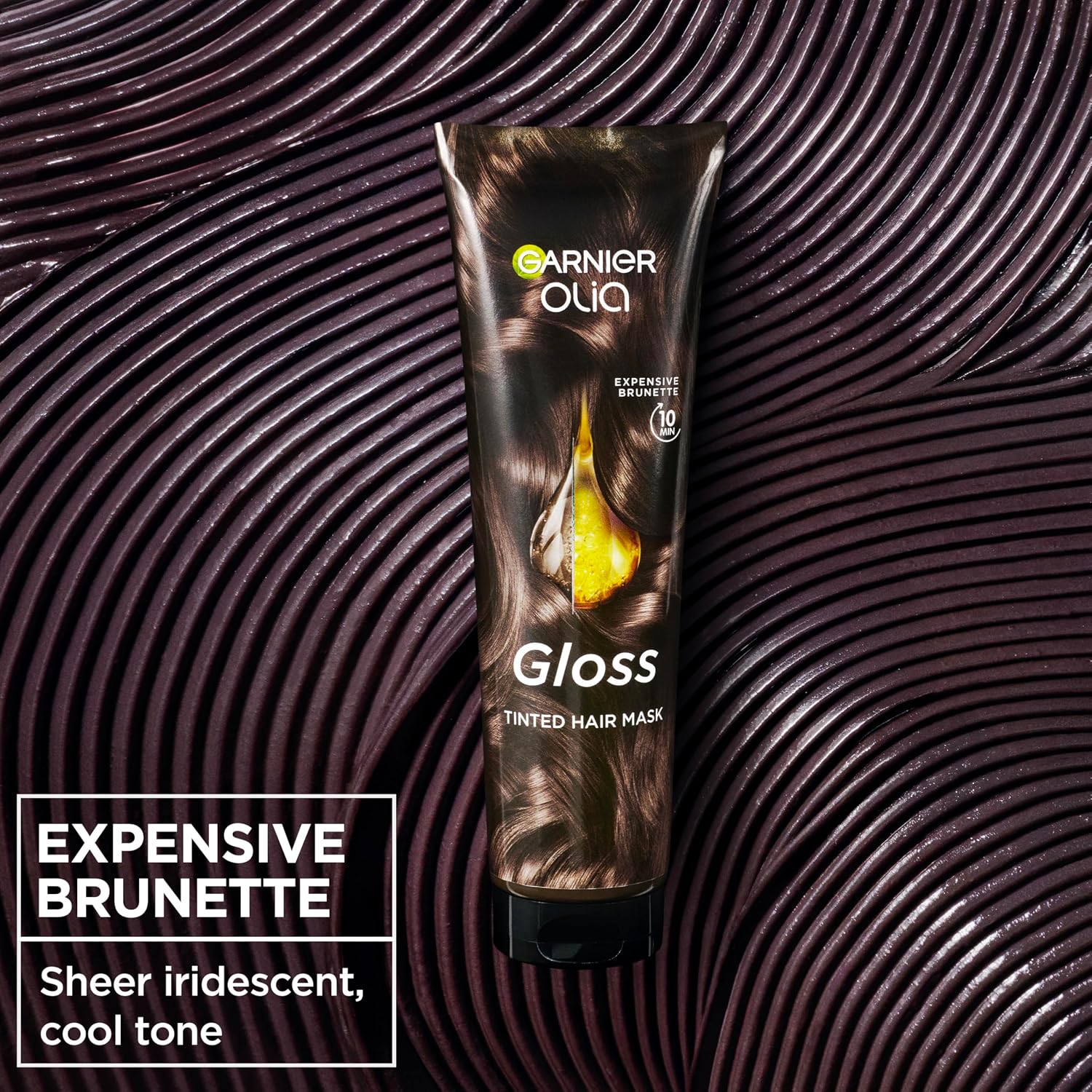 Garnier Olia Gloss Expensive Brunette Tinted Hair Mask 150ml on a dark glossy textured background, adding sheer brunette colour and shine in 10 minutes.