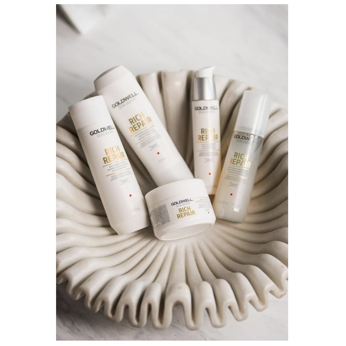 Goldwell Dualsenses Rich Repair haircare collection featuring shampoo, conditioner, 6 Effects Serum, treatment and serum spray for damaged hair repair.