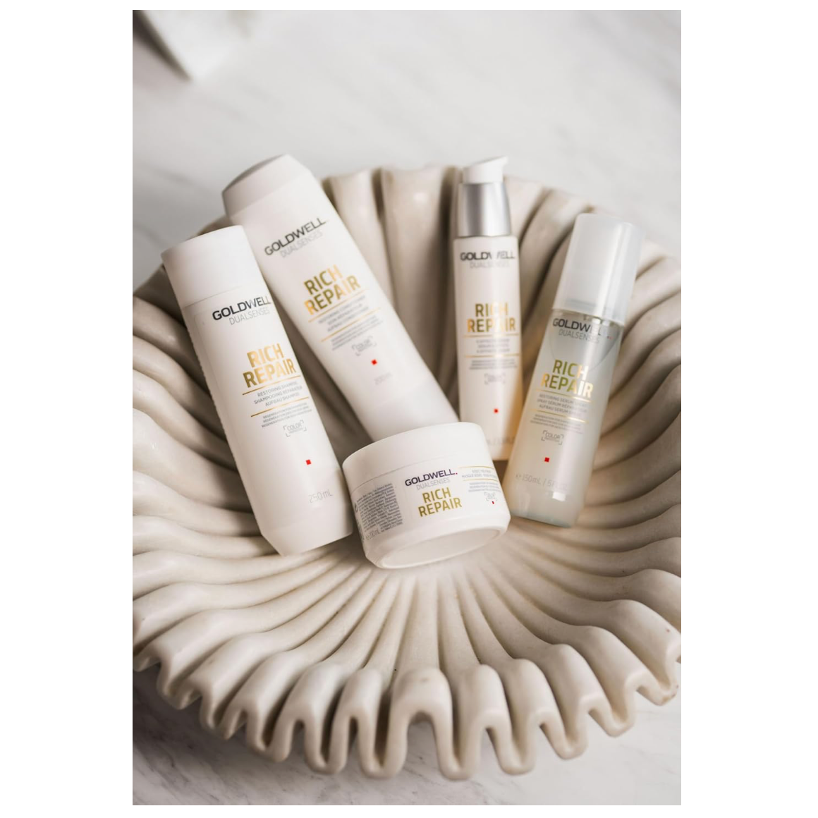 Goldwell Dualsenses Rich Repair haircare collection featuring shampoo, conditioner, 6 Effects Serum, treatment and serum spray for damaged hair repair.