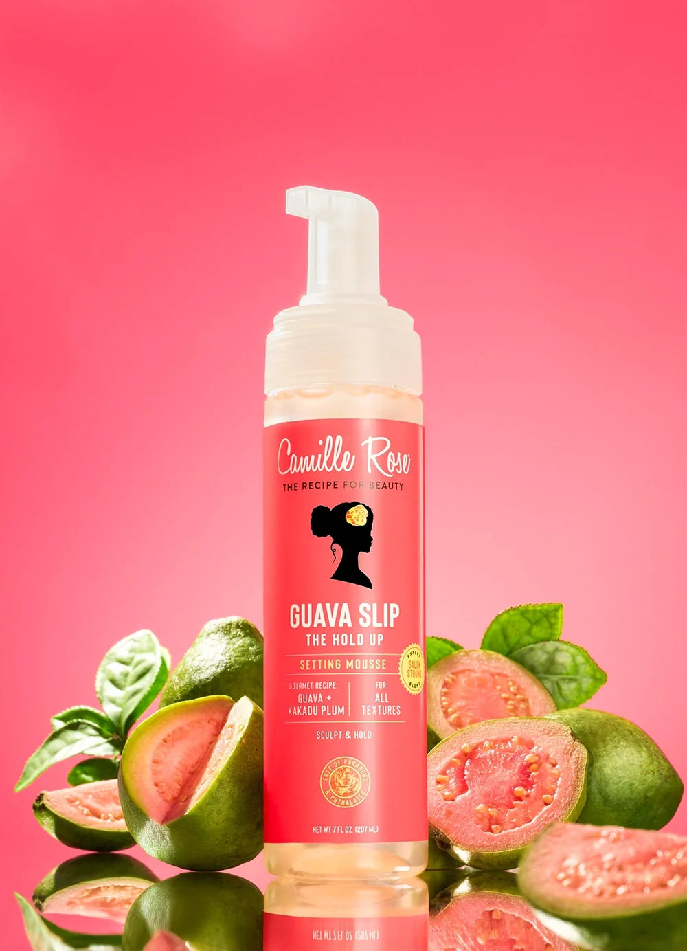 Bottle of Camille Rose Guava Slip Hold Up Setting Mousse 207ml | Kiyo Beauty product with guava fruits on a pink background
