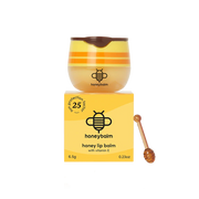 Honey lip balm with packaging and a wooden applicator on a white background
