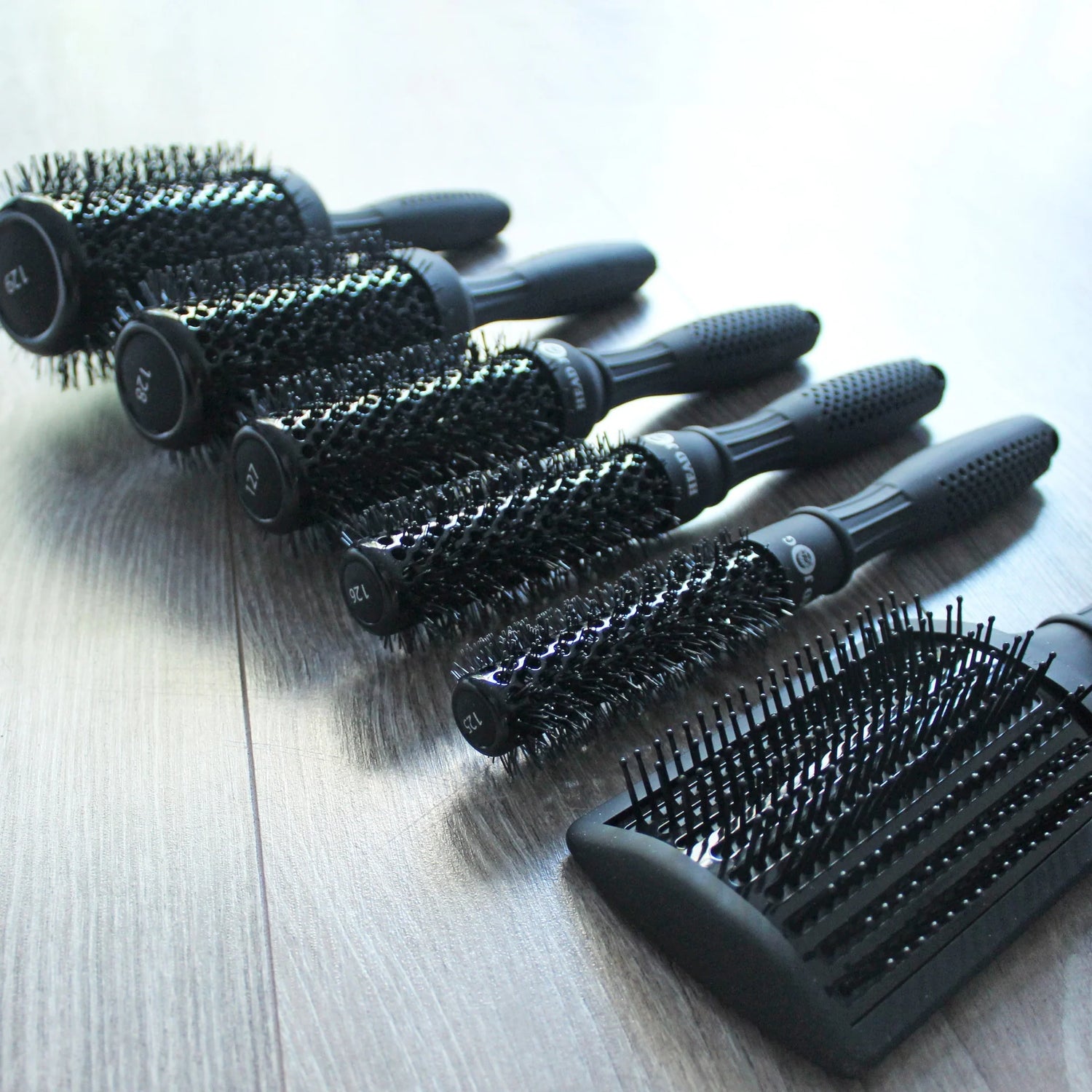 Head Jog Light professional hair brush collection featuring ceramic radial brushes and paddle brush with lightweight ergonomic handles for salon styling.