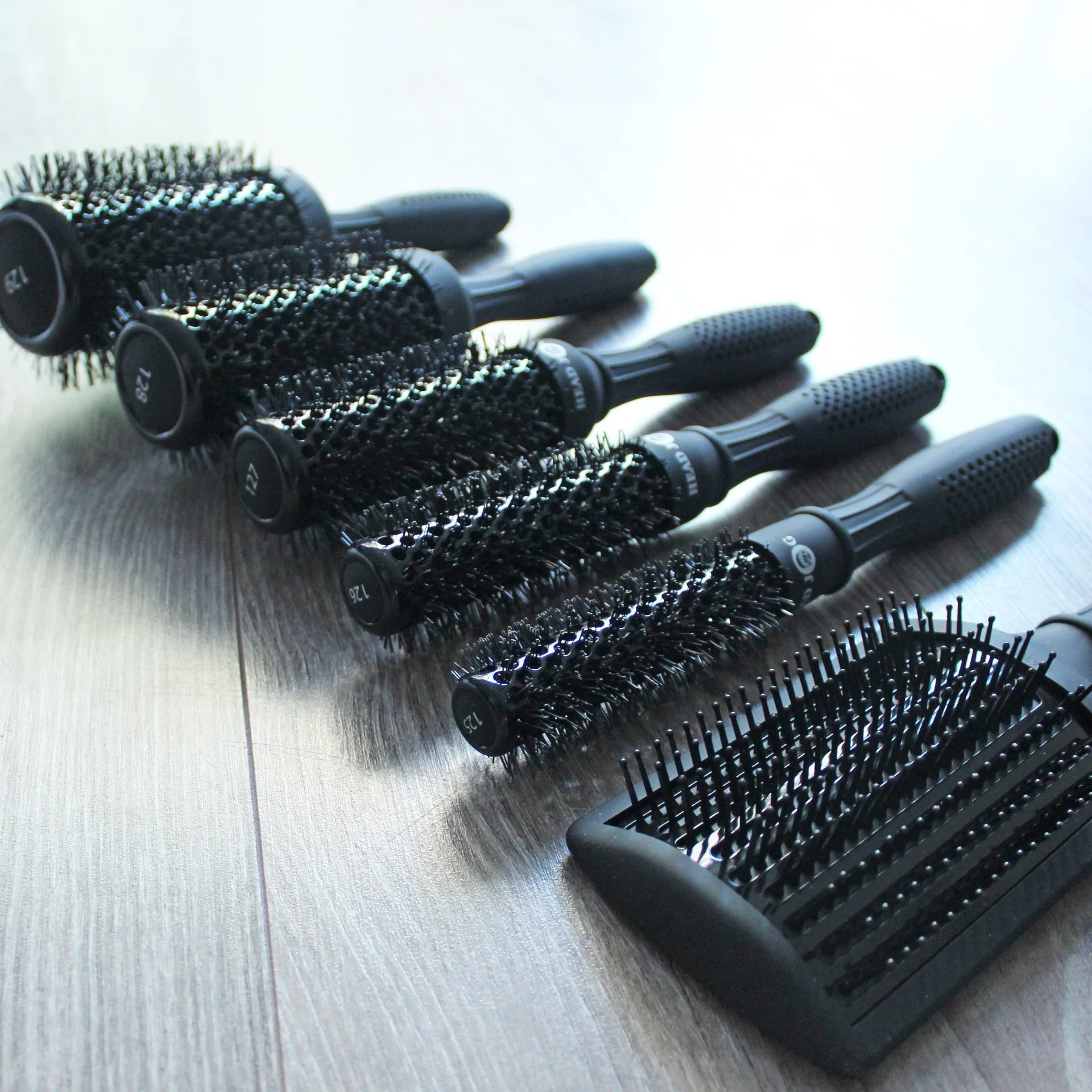Head Jog Light professional hair brush collection featuring ceramic radial brushes and paddle brush with lightweight ergonomic handles for salon styling.