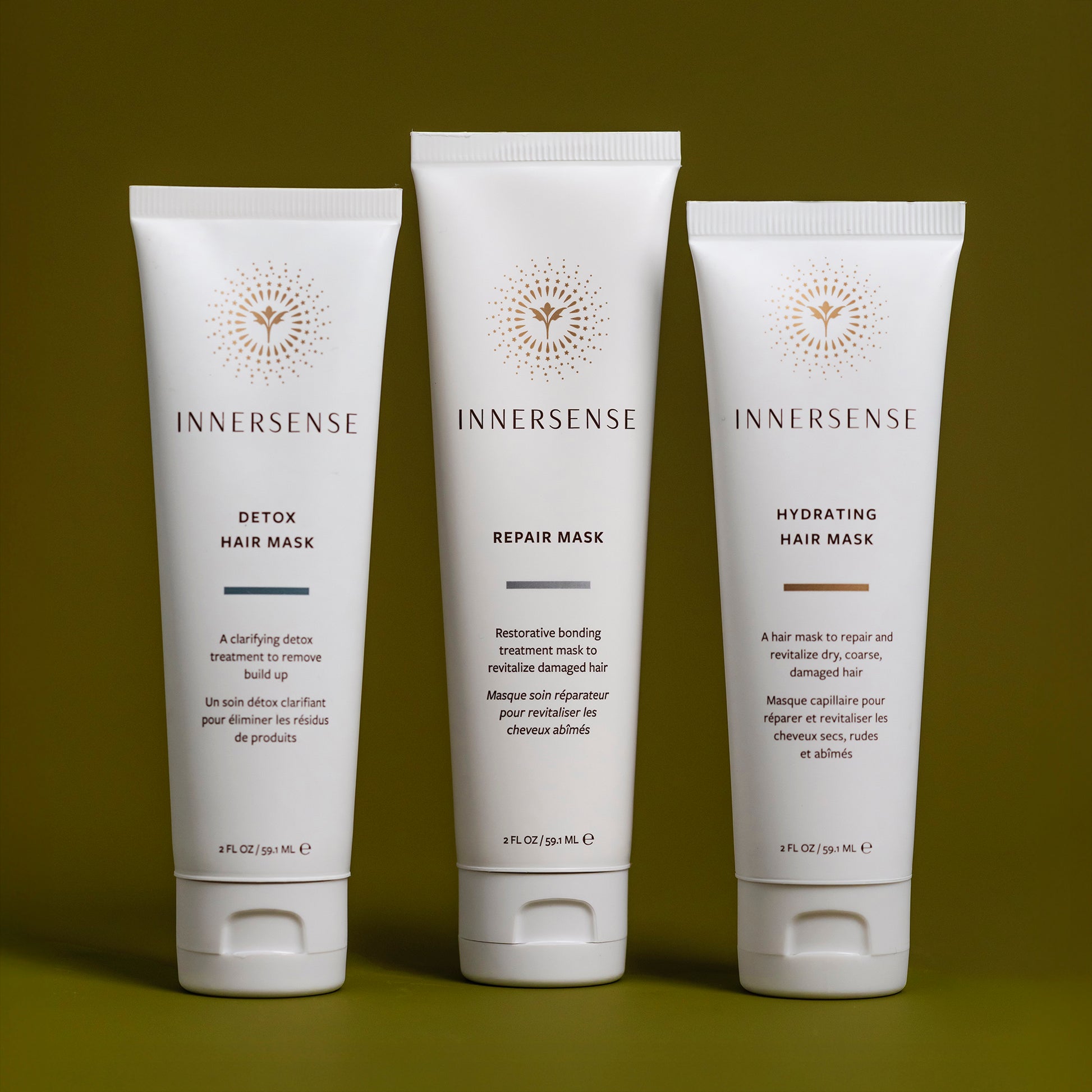 Three Innersense hair mask tubes on a green background