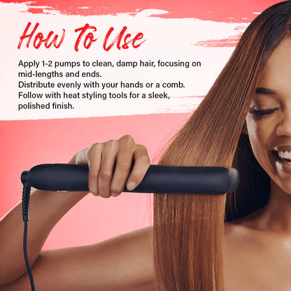 Smoothing heat protectant thermal serum onto hair strands before flat ironing.