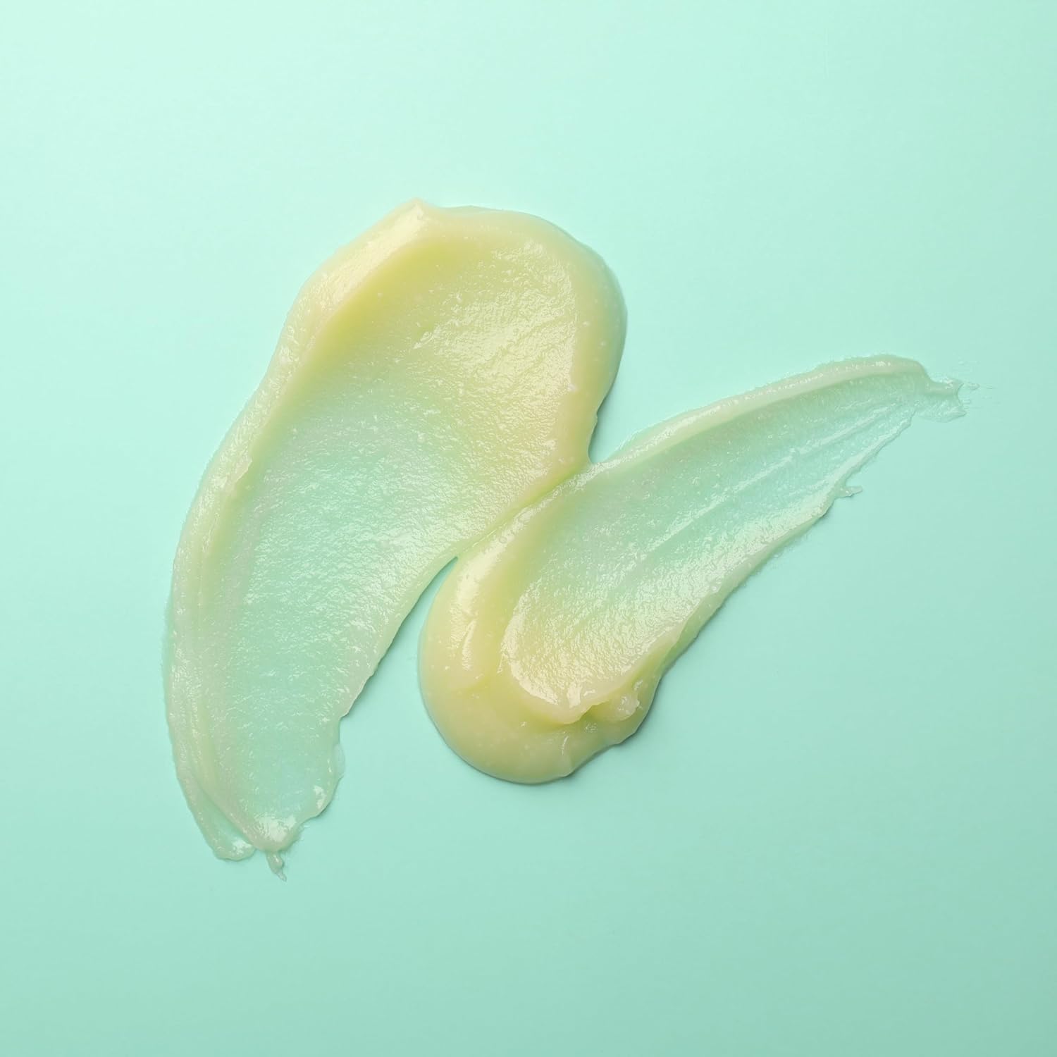 Hollywood Beauty Tea Tree & Rosemary Nourishing Scalp & Hair Balm 8oz product spread showing texture on a teal background