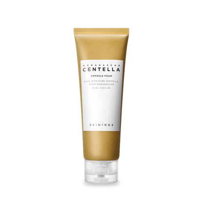 Skincare tube with gold and white design on a white background