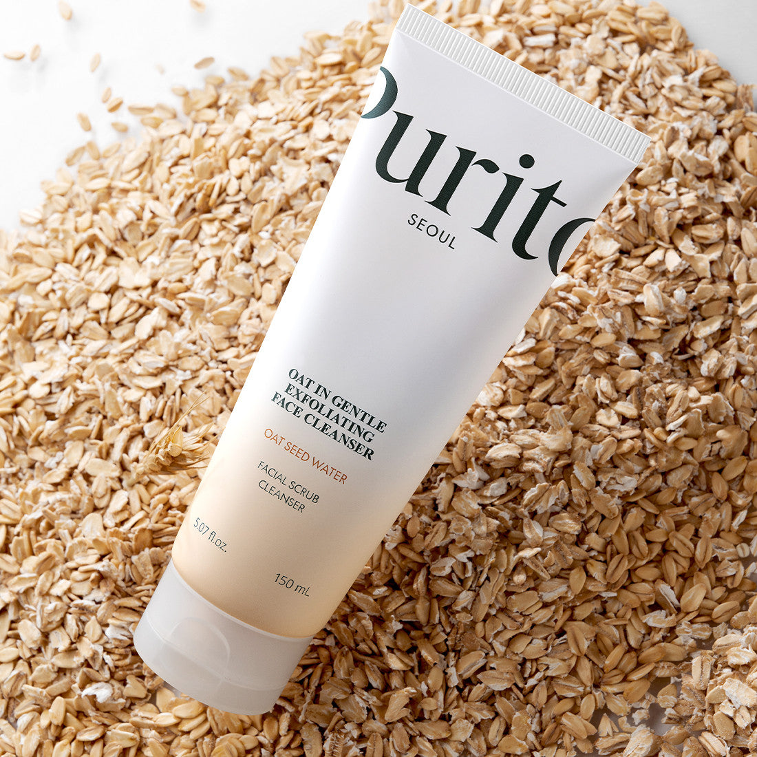Tube of Purito facial scrub cleaner on a bed of oats