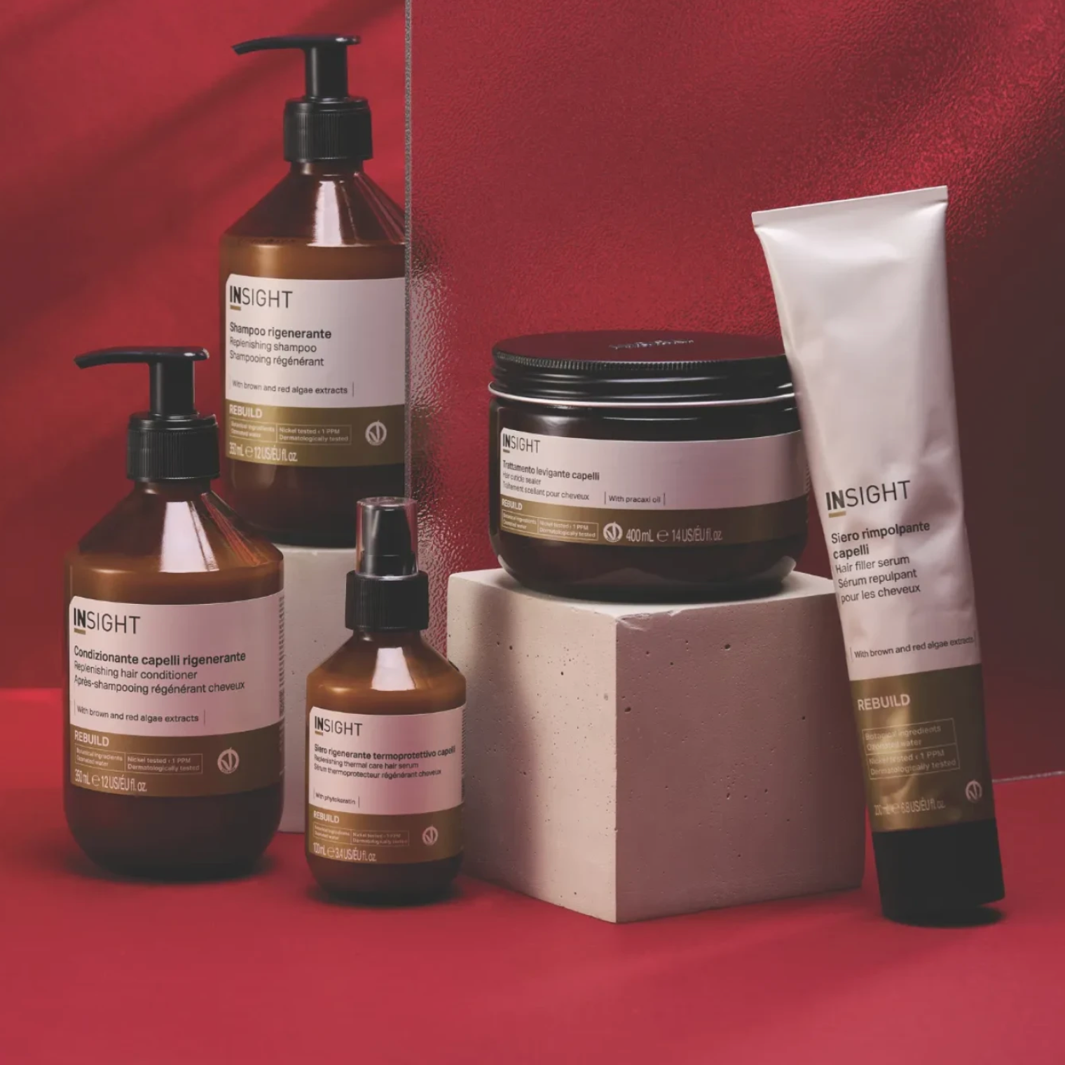 Insight Rebuild Hair Filler Serum 200ml displayed with the complete Rebuild range, including shampoo, hair mask and repair serums, on a red background
