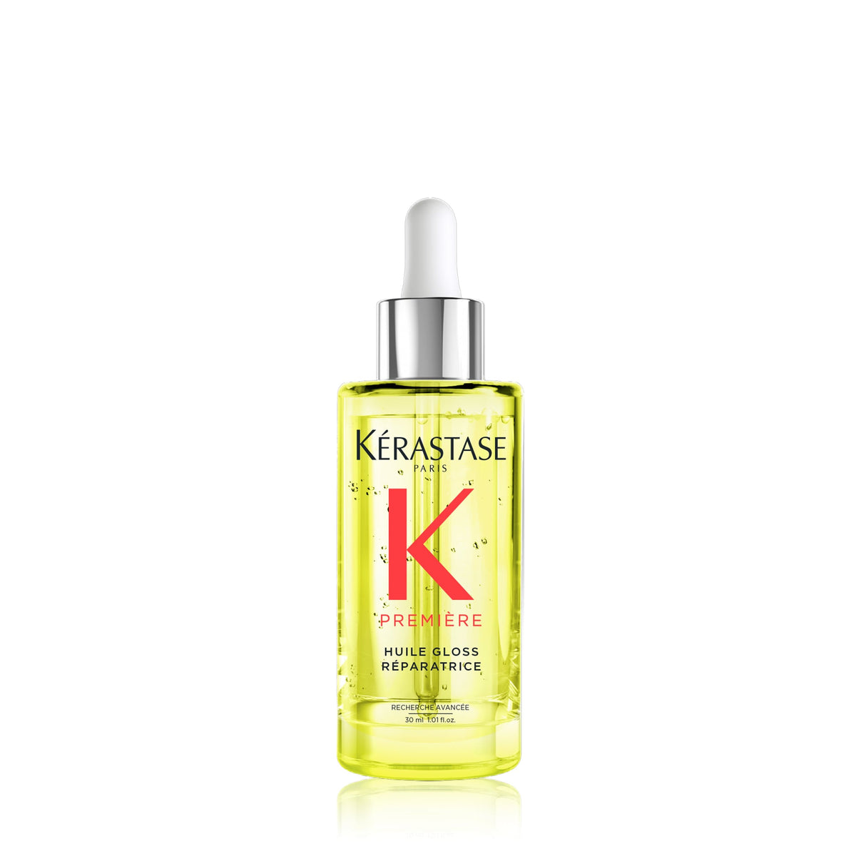 Kérastase Paris Premiere Hair Gloss Reparatrice in a clear glass dropper bottle filled with yellow oil, featuring a red 'K' logo and a white dropper cap, on a white background with a soft reflection.