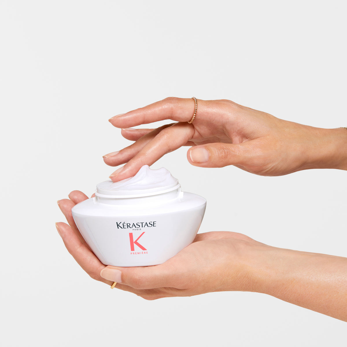 Kérastase Première Masque Filler Réparateur Repairing Hair Mask 200ml being held by a hand on a white background