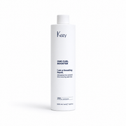 Kezy One Curl Booster 500ml curl boosting liquid for professional hair care, white bottle isolated on a white background with soft shadow, high-resolution e-commerce product photo.