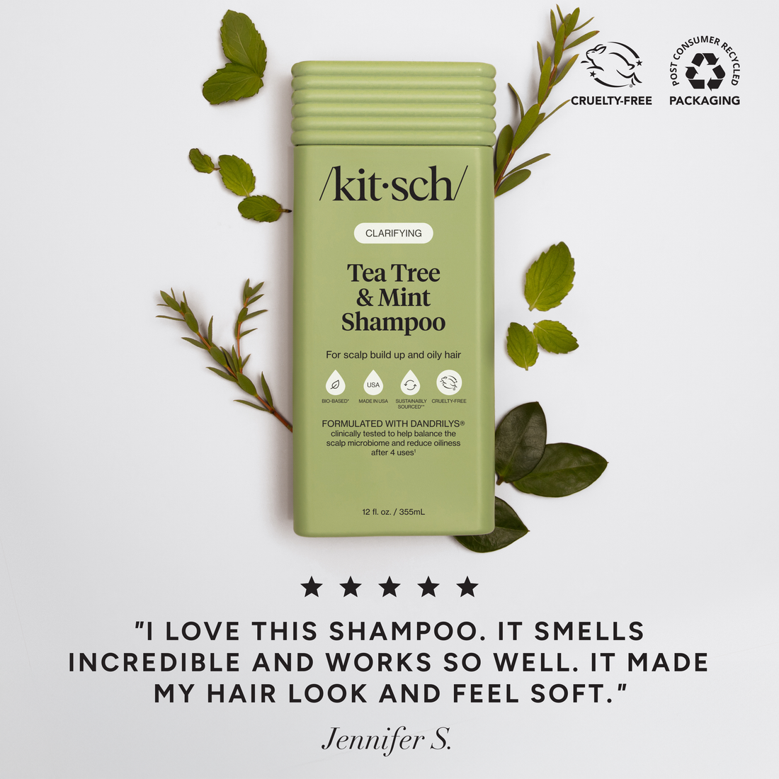 Kit-sch Tea Tree &amp; Mint Shampoo bottle with green leaves on a light gray background