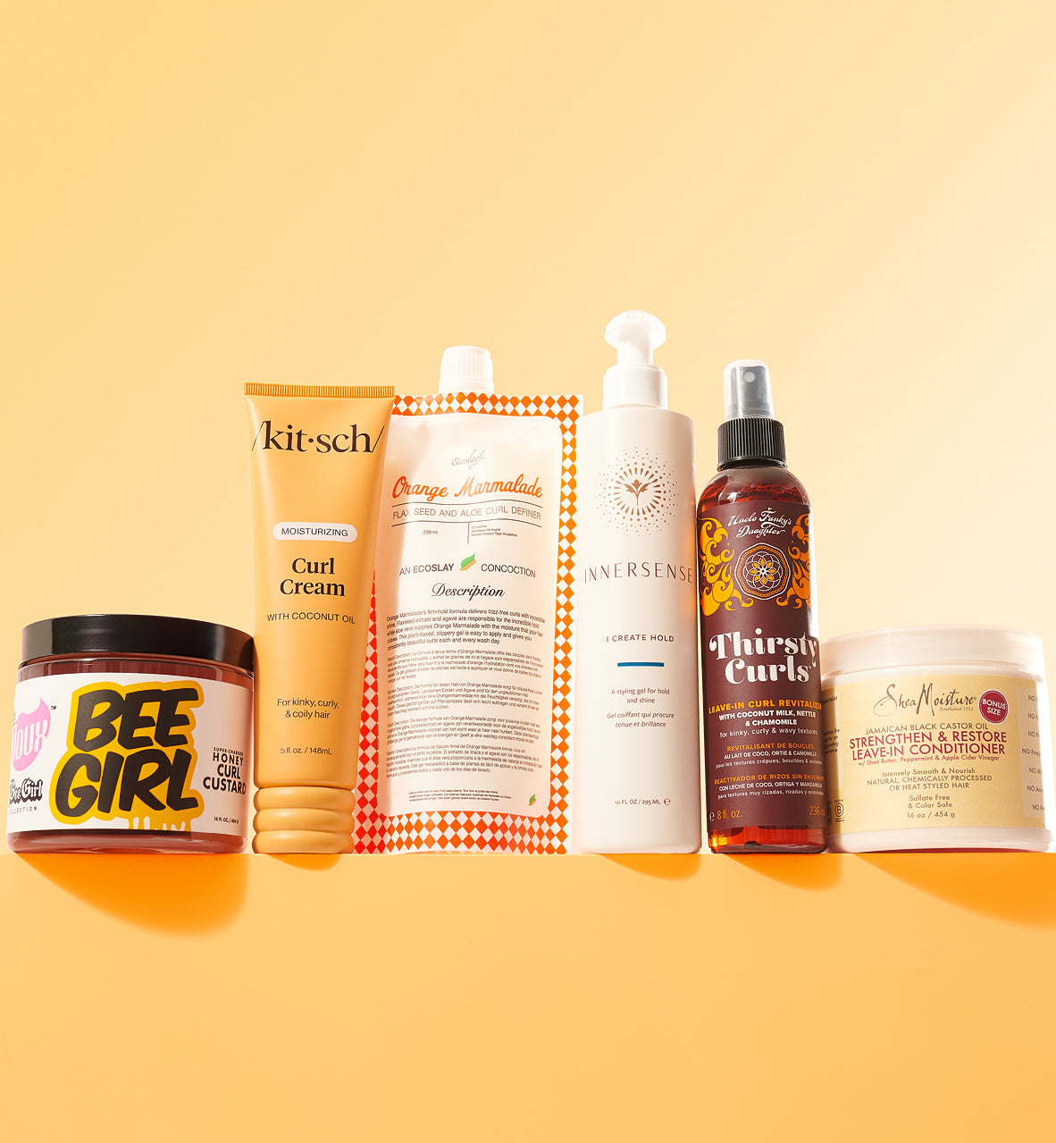 Collection of hair care products on a yellow background